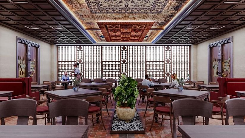 Dining area with chairs and tables, featuring a patterned ceiling at The Orchid Hotel, Chandigarh.