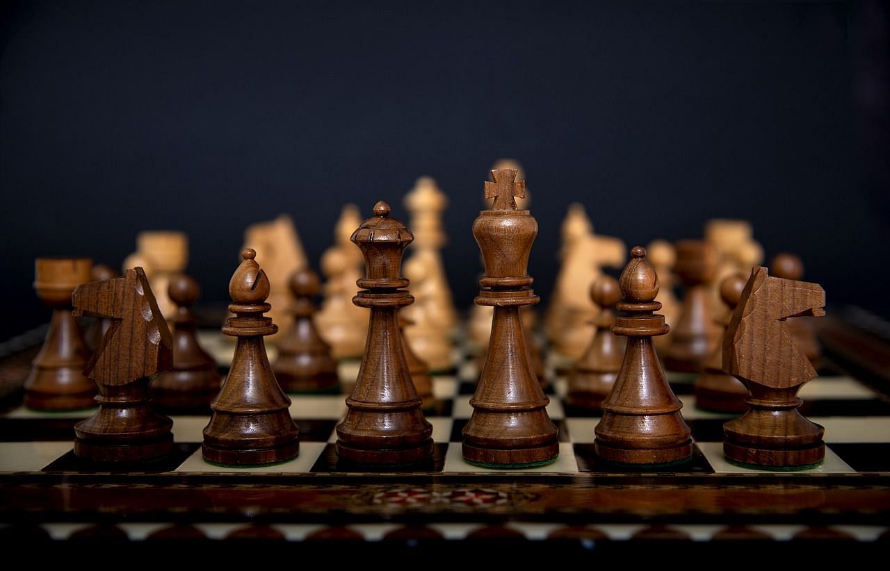 A close-up shot of the pieces of a chessboard, placed on top of a chessboard.