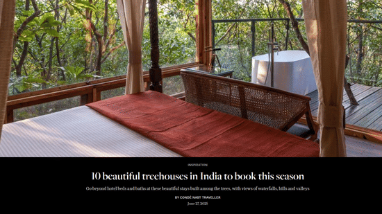 A Condé Nast Traveller article featuring the interior of a treehouse bedroom complete with a private outdoor bathtub on the balcony at Tranquil Resort, Wayanad.