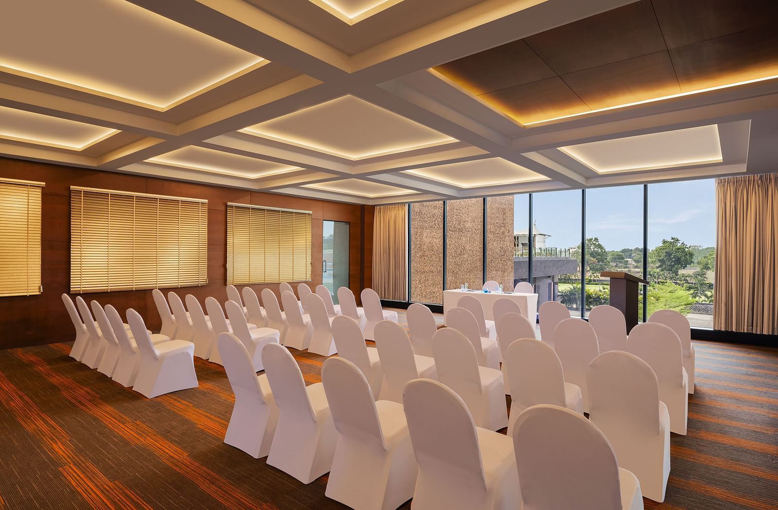 Carnival Hall at Essentia Luxury Hotel, Indore with large windows and a conference arrangement