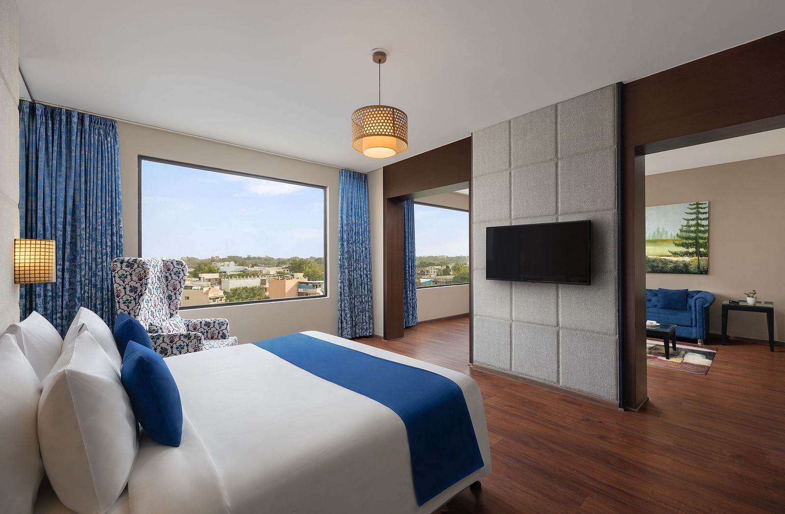 Dleuxe Suite at Essentia Luxury Hotel, Indore with a double bed, a television and a separate living area