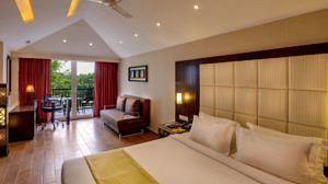 The room with bed, sofa, desk, balcony and chairs