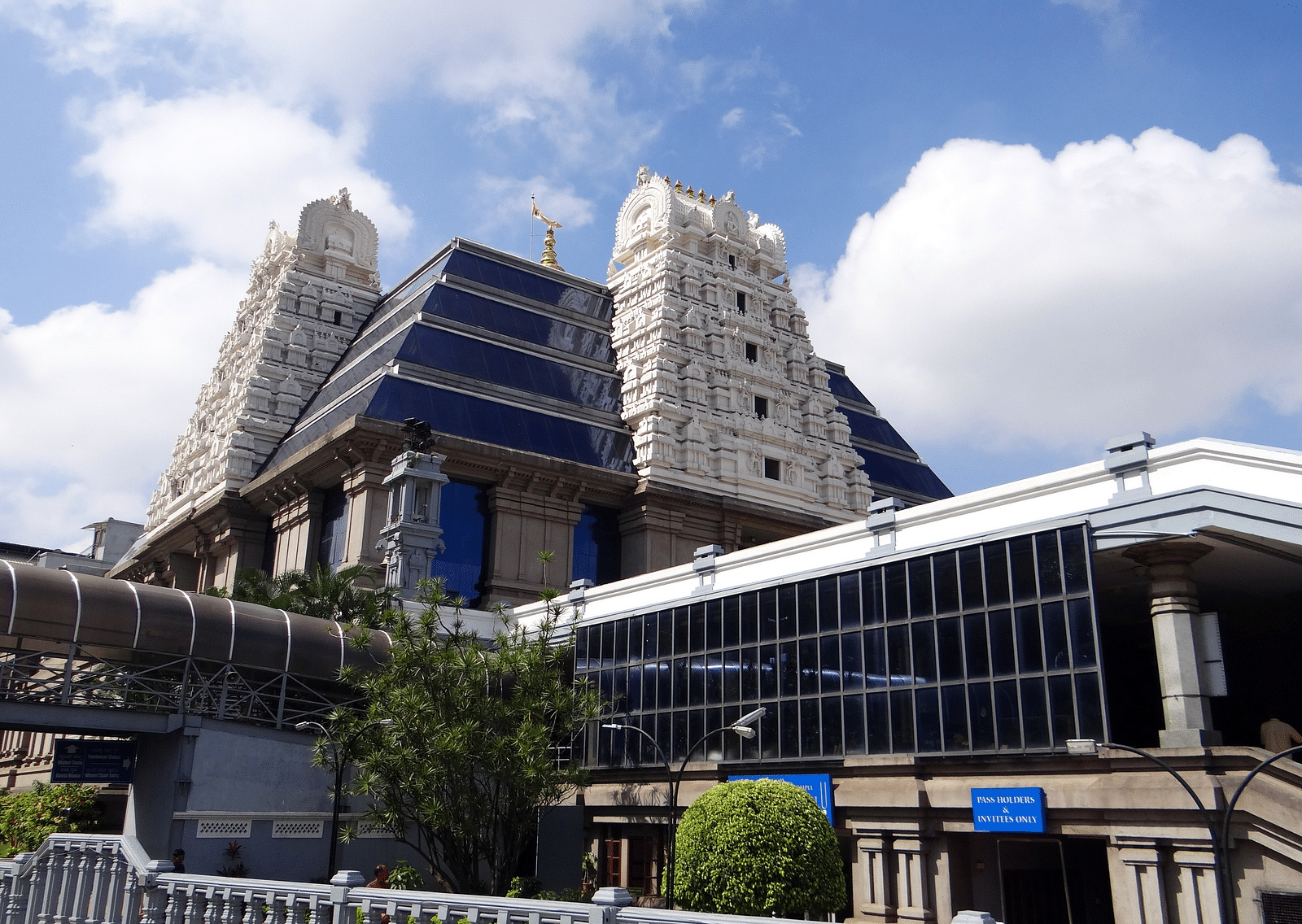 An overview of ISKCON temple in Indore with white clouds on blue sky in the background.
