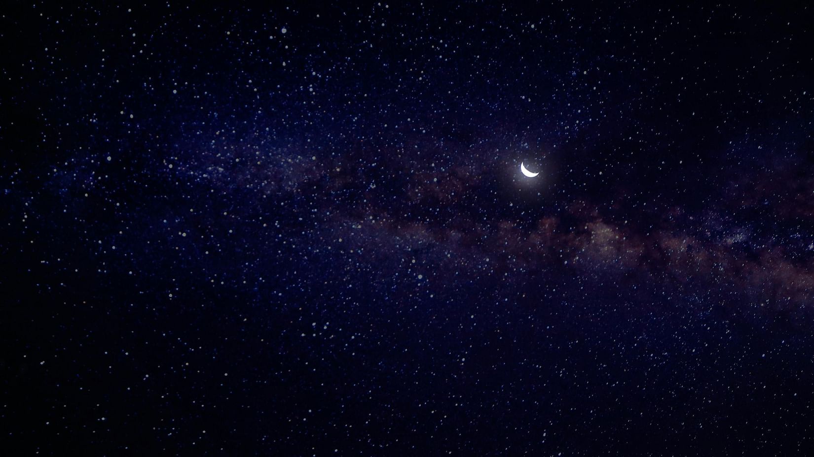 A sky full of twinkling stars where the moon shines bright.