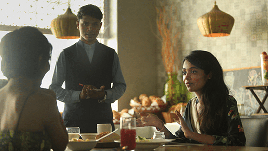 two women dining at our cafe and a waiter standing beside them at The Residency Towers Rameswaram