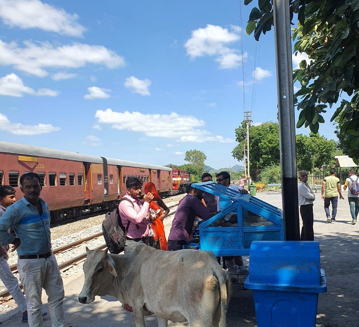 image showing some people waiting on a platform for a train to pass