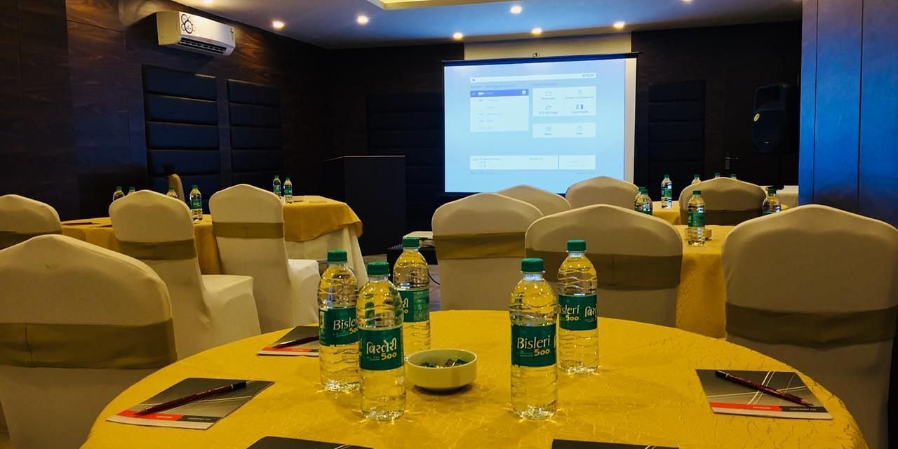 Image of a round table with water bottles and notepads placed on it at Calux Grand Baga.