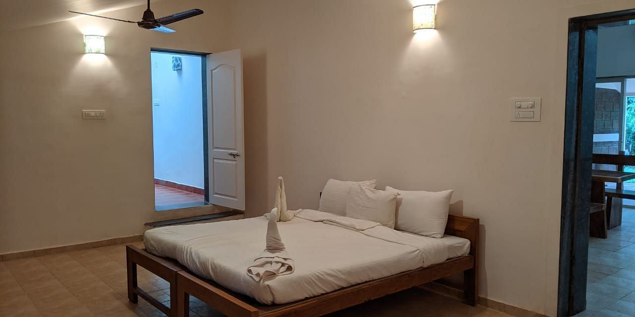 A bedroom with a minimalist design and a bed at The Conservancy Bungalow.