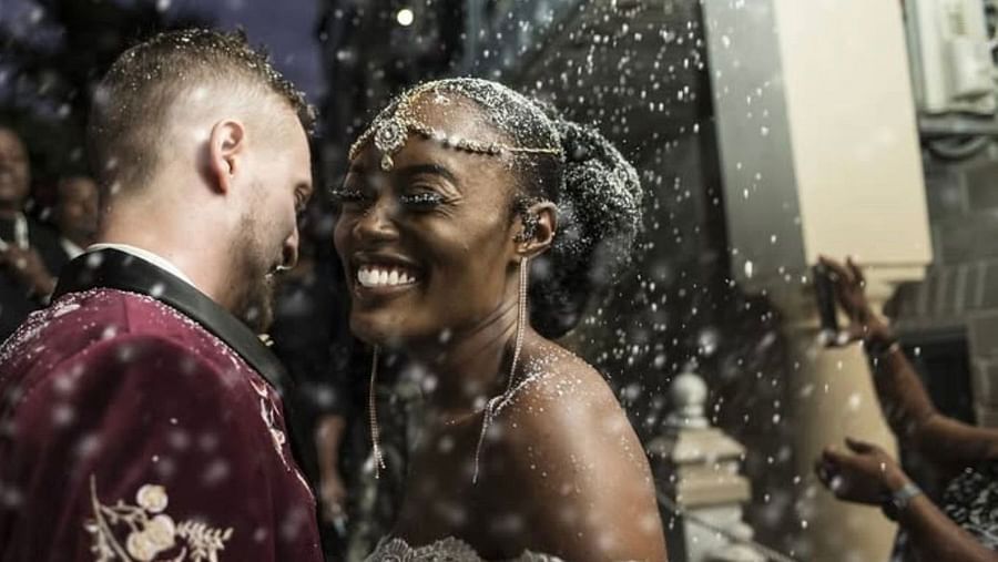 A couple smiling during wedding celebration with confetti in the air | A Stone's Throw Away