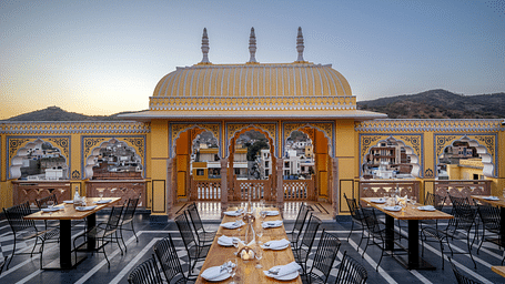 a bright image of the rooftop dining area with tables well arranged with plates and cutlery13-March-2025