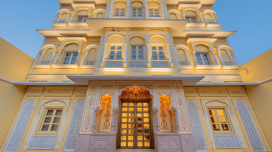 facade image of the hotel with exterior lights illuminating the building taken from a lower angle - Brij Castle, Jaipur