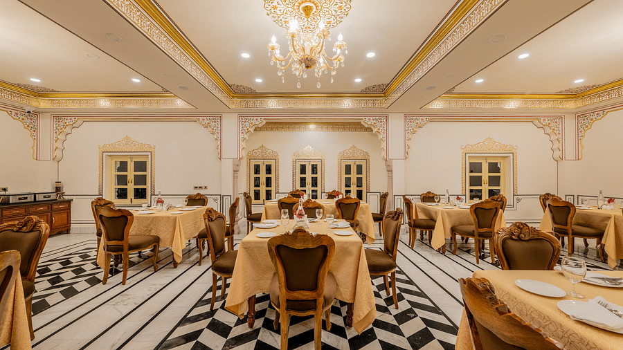 full view image of our multi-cuisine restaurant with an elegant chandelier hanging from the top - Brij Castle, Jaipur