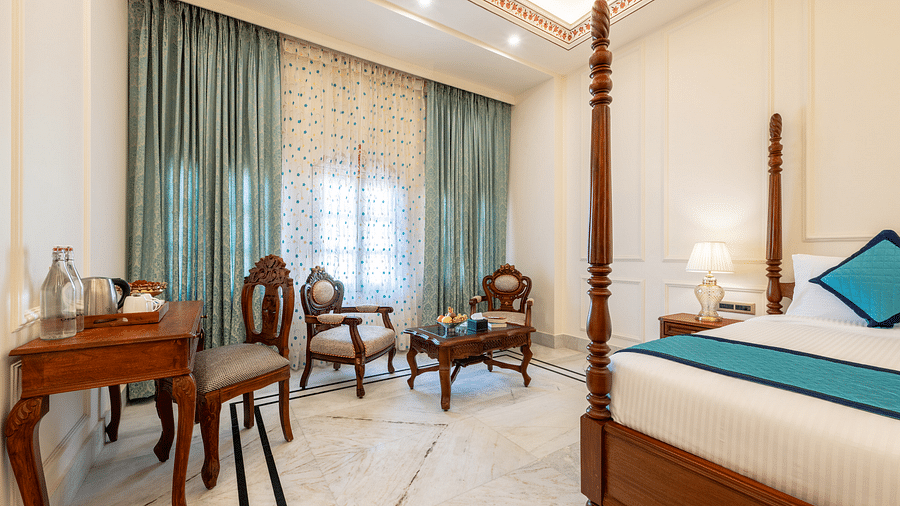 a bedroom featuring the common seating area along with a work desk and chair - Brij Castle, Jaipur