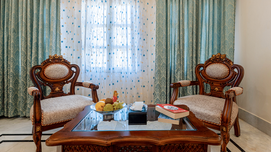 a close up image of a common seating area with two cushioned armchairs - Brij Castle, Jaipur