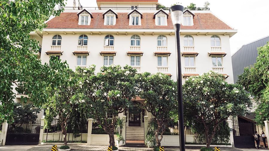 A full view of a stately building with a pitched roof, set against a clear sky | Central Mansions, Phnom Penh