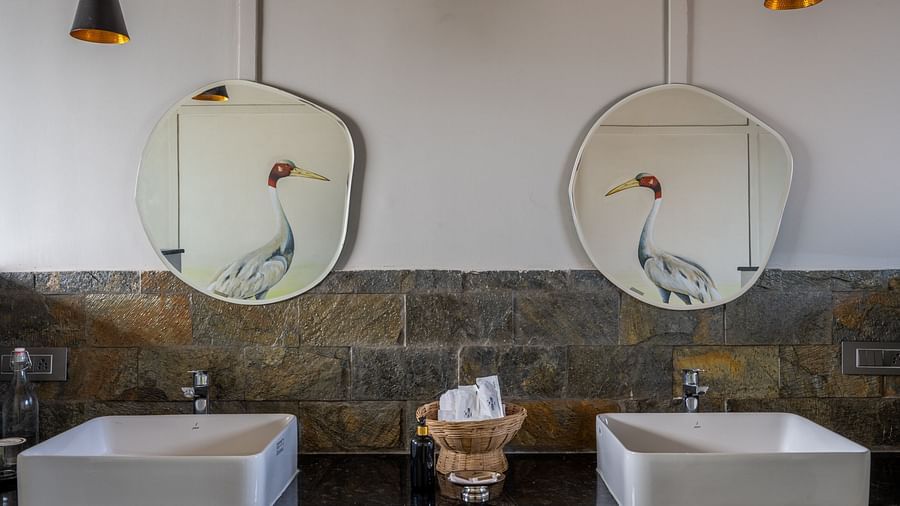 An image of a washroom with two wash basins and mirrors - Utsav Camp Sariska
