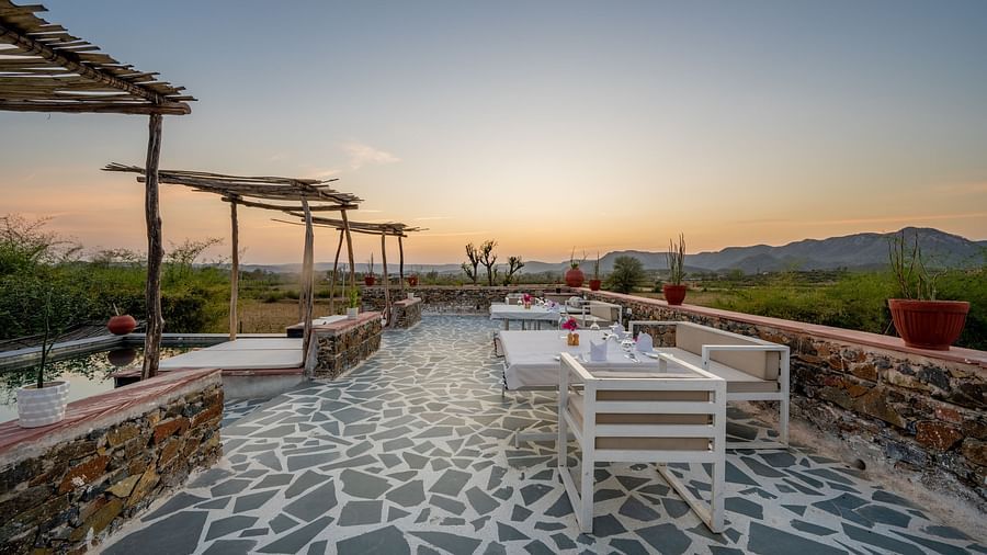 An image of a seating arrangement near the swimming pool in the open - Utsav Camp Sariska