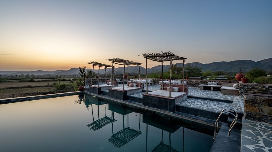 An image of a seating arrangement near the swimming pool in the open - Utsav Camp Sariska