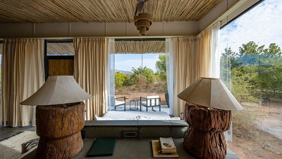 An image of a room with decorative lamps, chandelier, a ceiling fan - Utsav Camp Sariska