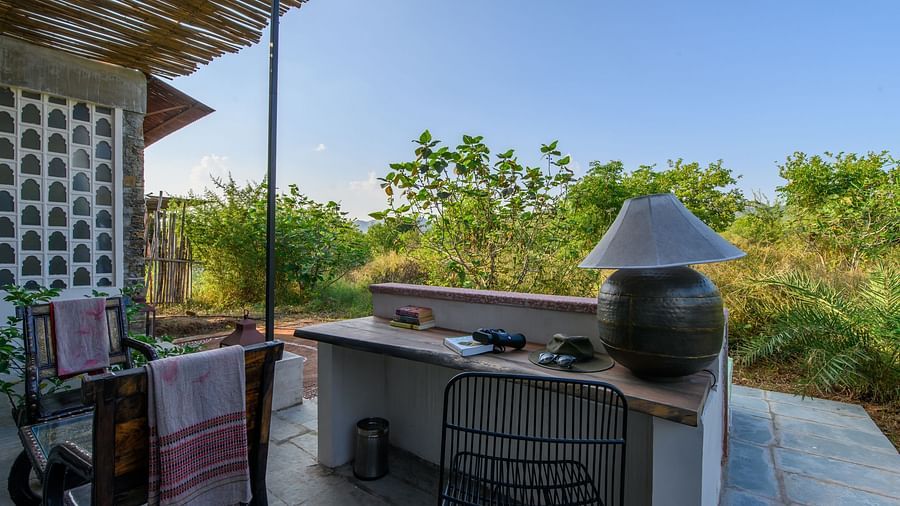 An image of an outdoor seating over viewing the greenery around Utsav Camp Sariska