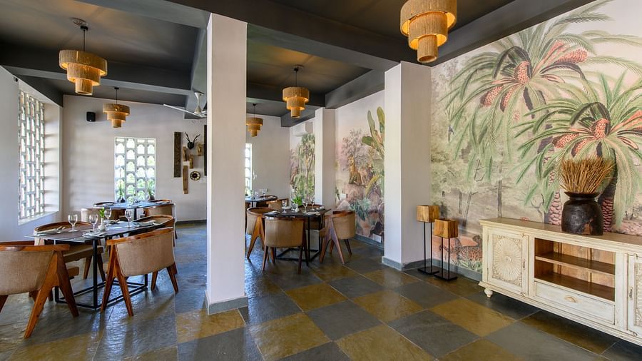 An image of a restaurant with with seating arrangement and buffet with minimal decoration - Utsav Camp Sariska