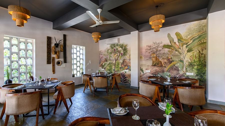 An image of a restaurant with with seating arrangement and buffet with minimal decoration - Utsav Camp Sariska