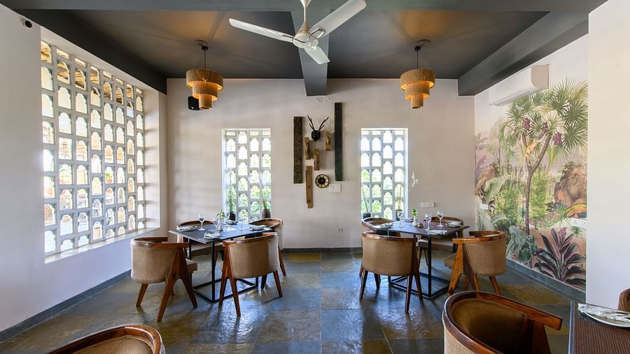 An image of a restaurant with with seating arrangement and buffet with minimal decoration - Utsav Camp Sariska