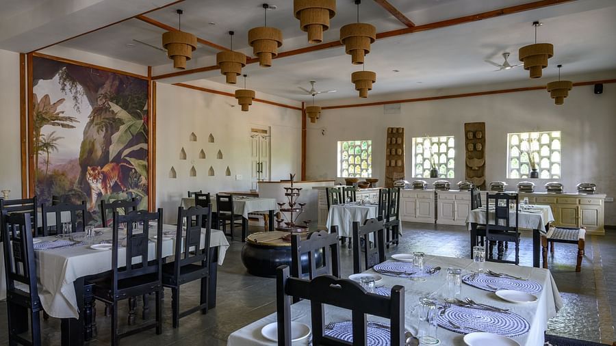 An image of a restaurant with with seating arrangement and buffet with minimal decoration - Utsav Camp Sariska