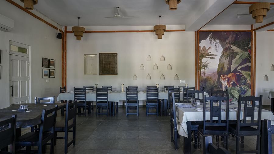 An image of a restaurant with with seating arrangement and buffet with minimal decoration - Utsav Camp Sariska