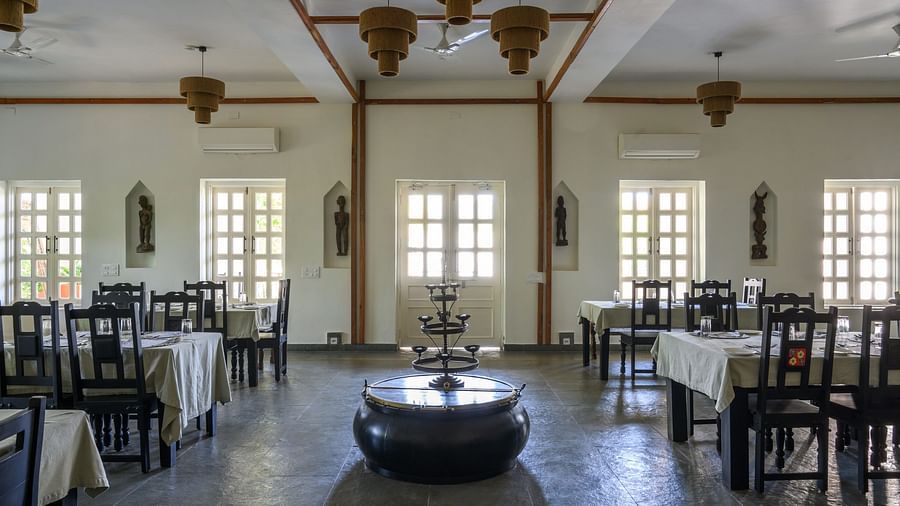 An image of a restaurant with with seating arrangement and buffet with minimal decoration - Utsav Camp Sariska