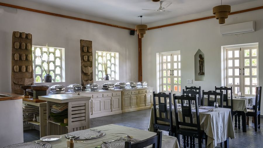 An image of a restaurant with with seating arrangement and buffet with minimal decoration - Utsav Camp Sariska