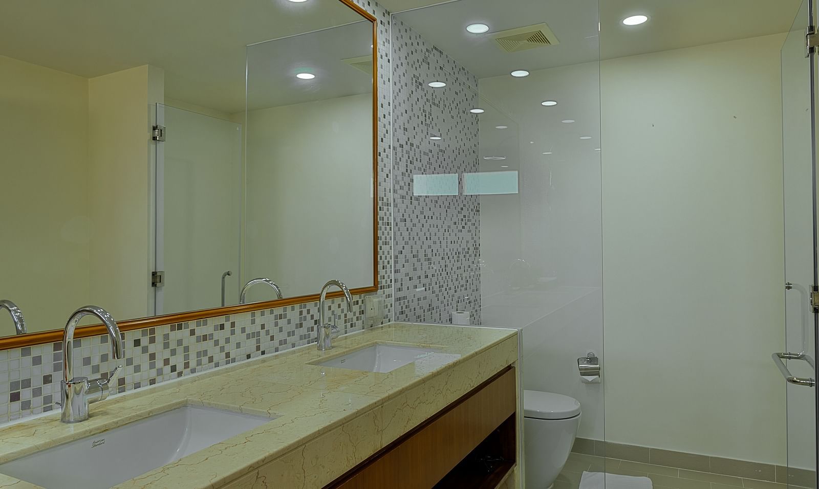 A spacious bathroom with a long vanity, double sinks, and a large mirror | Penthouse | Central Mansions, Phnom Penh
