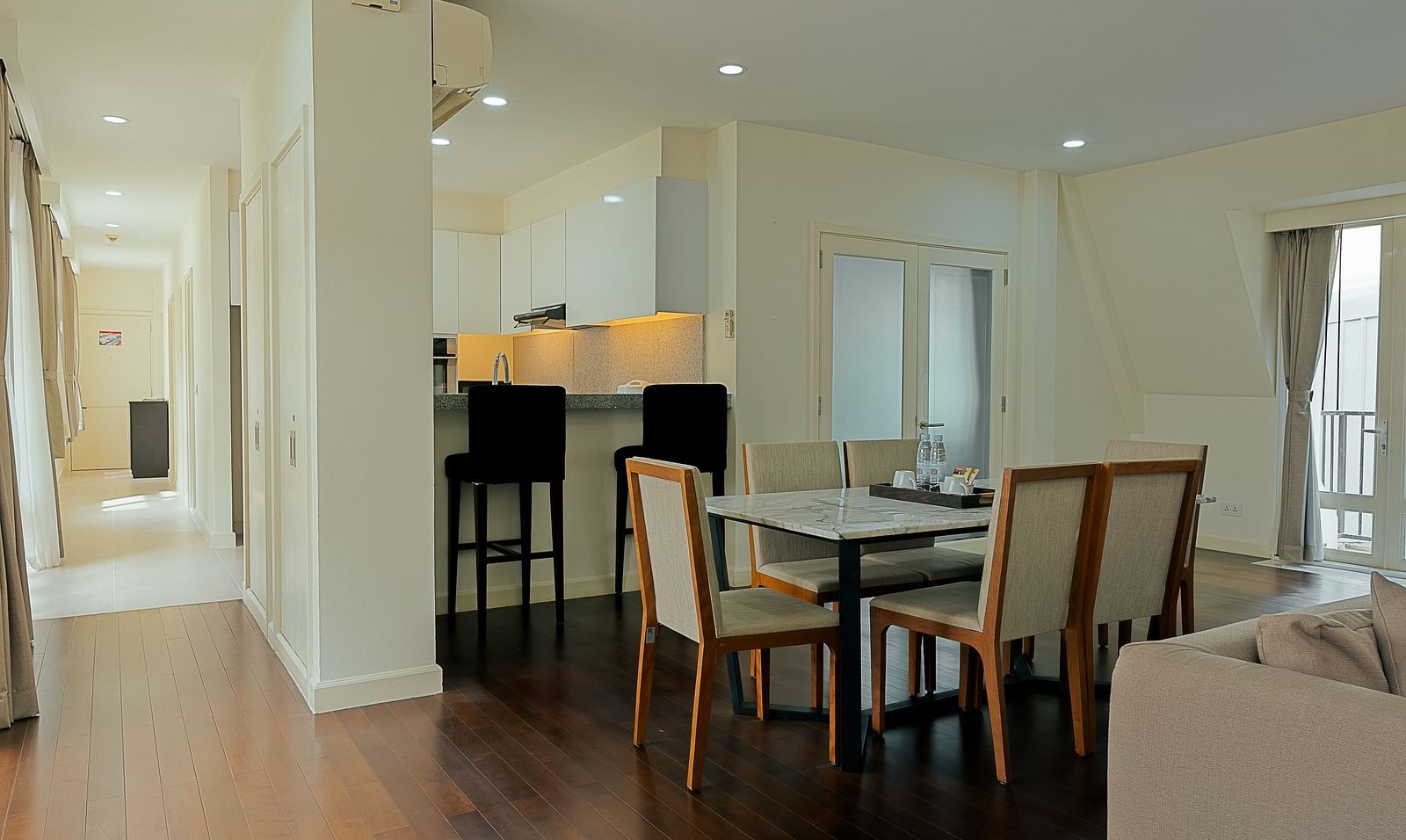 A dining room with a table and chairs | Four-bedroom Suite | Central Mansions, Phnom Penh