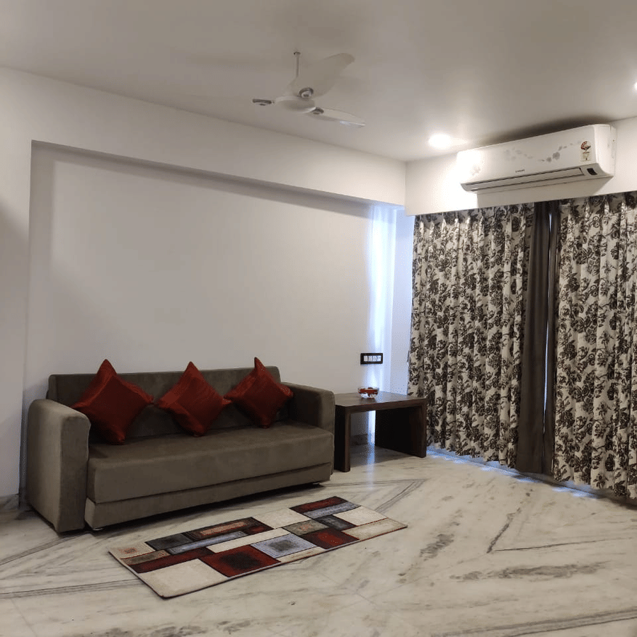 Royal suite living space with a  well furnished sofa and air-conditioner.