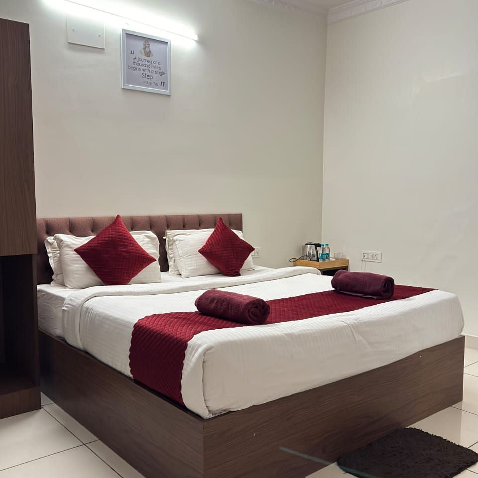 A bed with plush bedding in a bedroom | Vistar Resort, Bengaluru
