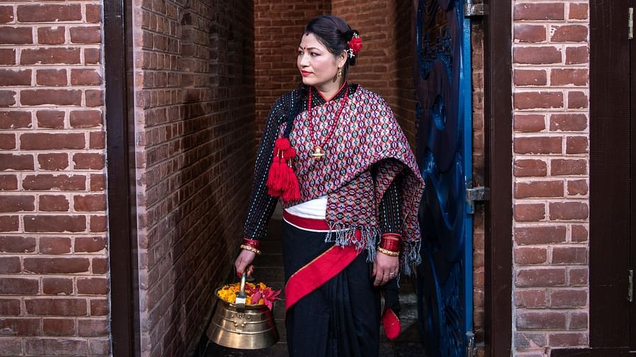 A women wearing the traditional Nepali attire standing at the Street Entrance of The Nanee