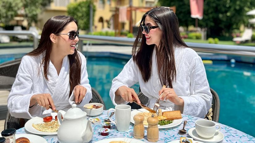2 women enjoying a poolside breakfast spread - Heritage Village Resort & Spa, Manesar
