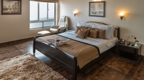 a well made bed at one of the rooms 14