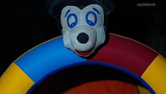 A child playing in a mickey slide at Themis Mudhouse - A Nature