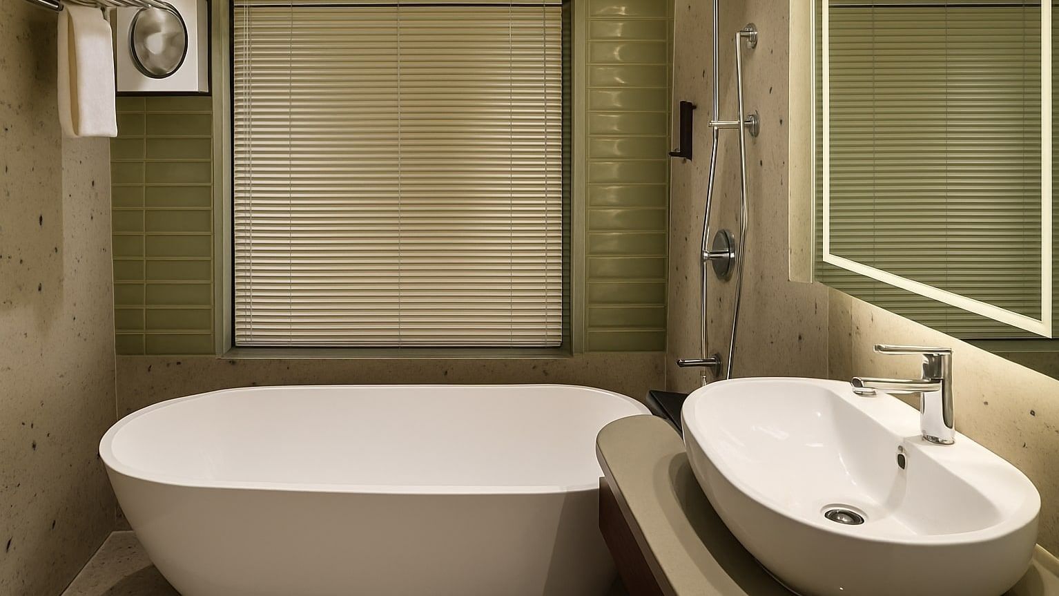 A bathroom at Premium Ganges View Room at Summit by the Gangs Beach Resort and Spa featuring a bathtub, a washbasin with faucet, a mirror on the wall, and other toiletries.