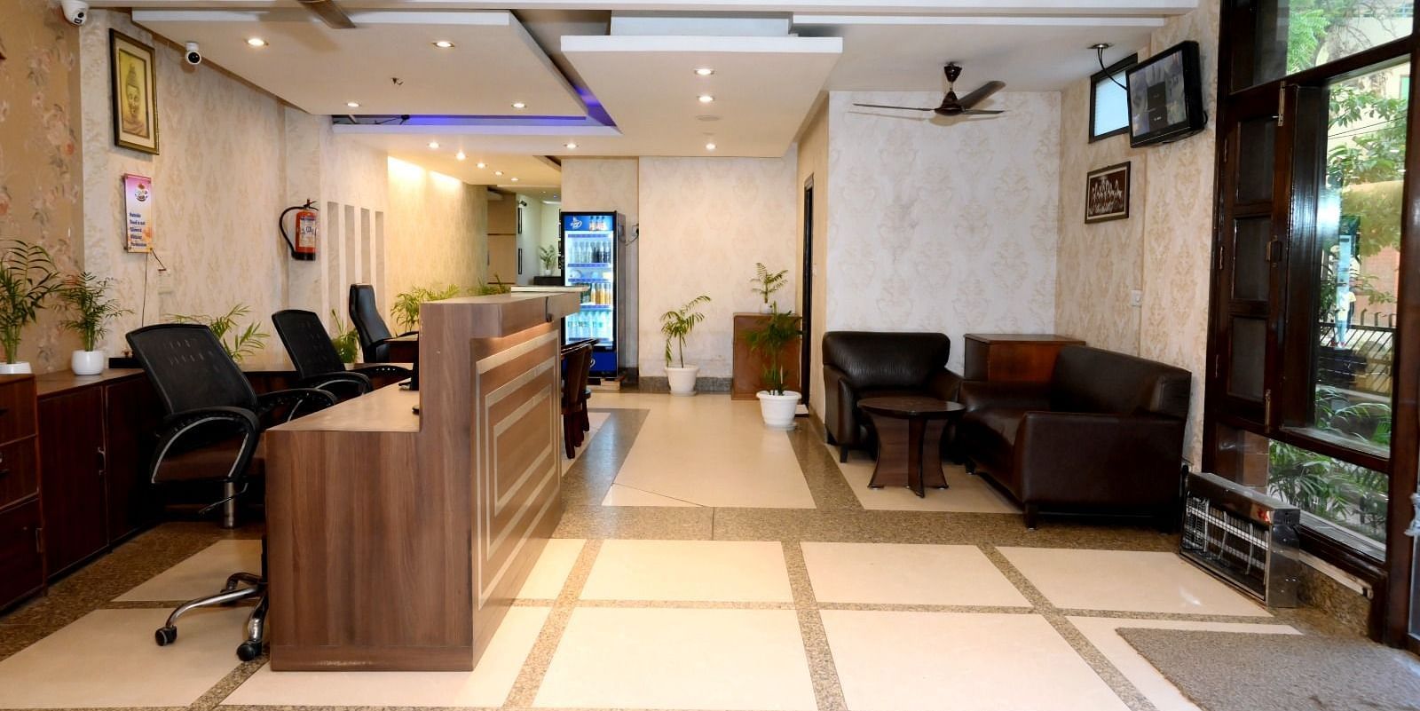 A welcoming hotel reception with a front desk, sofas, and decorative lighting - Hotel Diamond Inn, Chandigarh