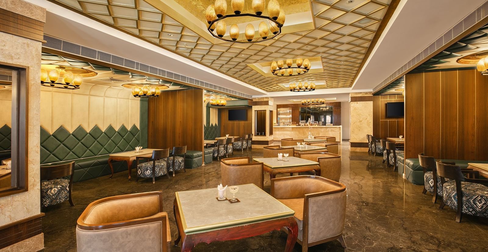 An upscale bar in Mahabalipuram with contemporary interiors and golden accents - Kaldan Samudhra Palace