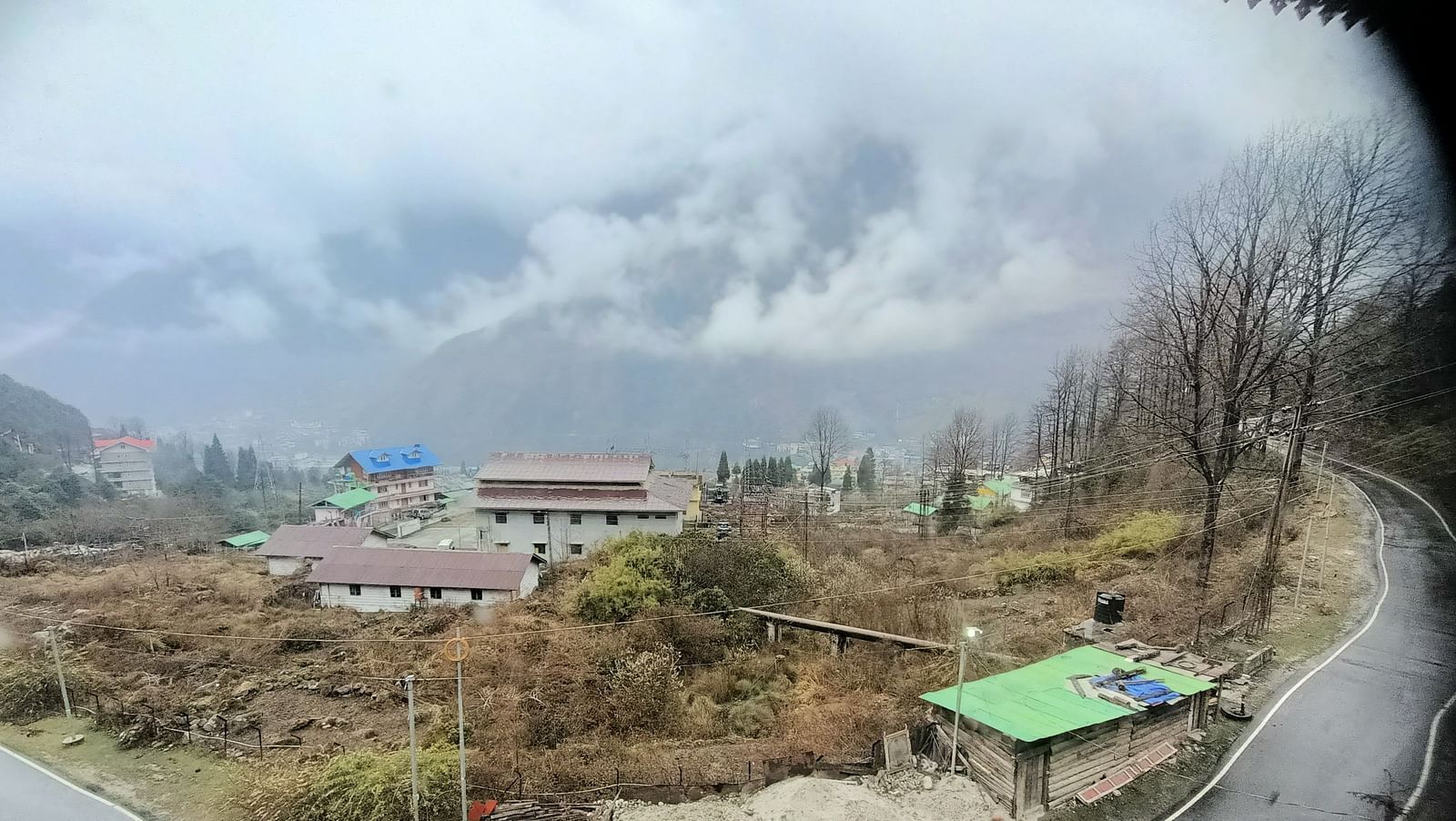 View of buildings and mountains from a balcony of our hotel