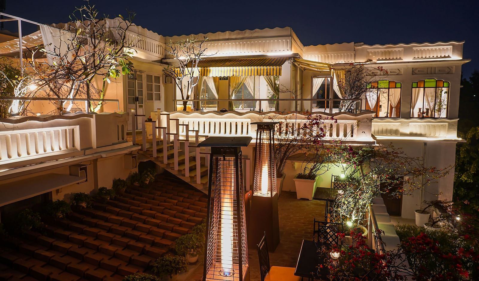 Exterior of well-lit Saraca Bar at Saraca Hotel, Lucknow at night
