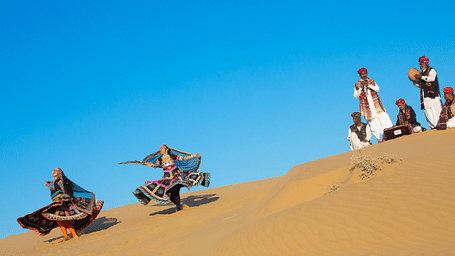 Artisans performing the local dance in the desert