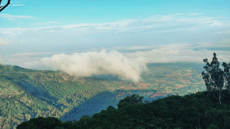 A hill station offering a scenic vista under a blanket of clouds