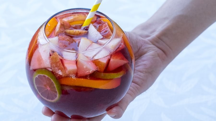 A person holding a glass of Sangria  | Mango Hill, Pondicherry
