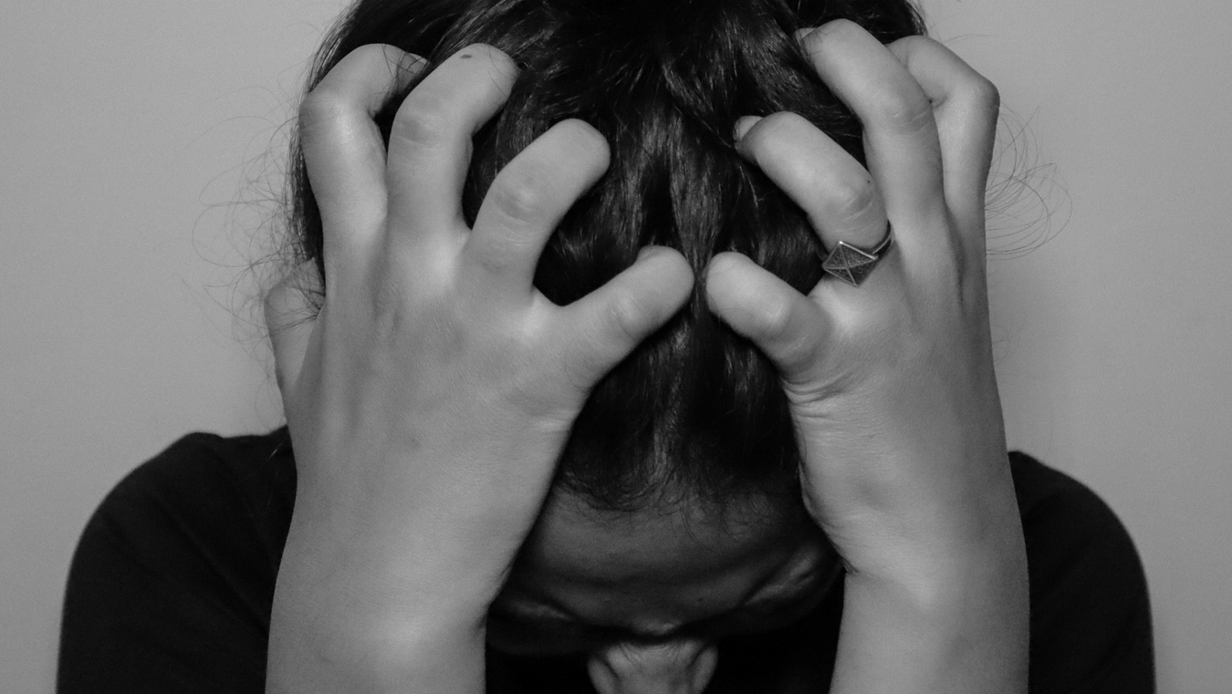 a person holding their head trying to get through a panic attack