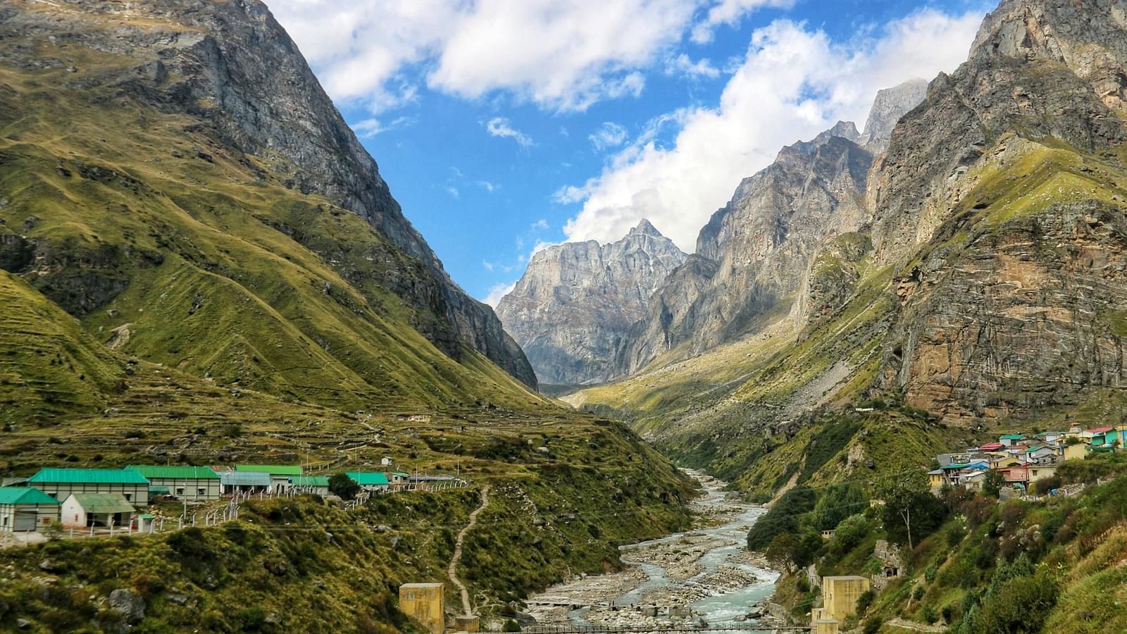Image of Mana Village with a stream flowing and hosues on the side of the valley | Faraway Cottages, Auli