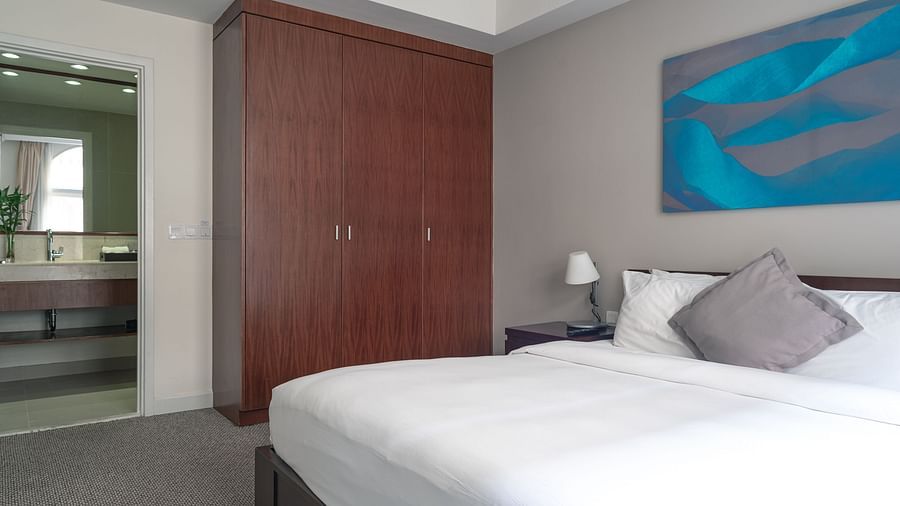 A bedroom with a large bed and a closet | Two-bedroom Suite | Central Mansions, Phnom Penh
